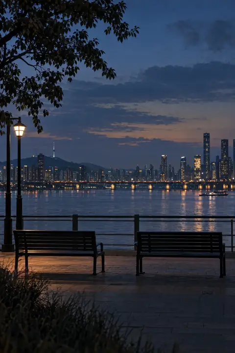 Original editorial illustration of quiet benches beside a city river at blue hour.